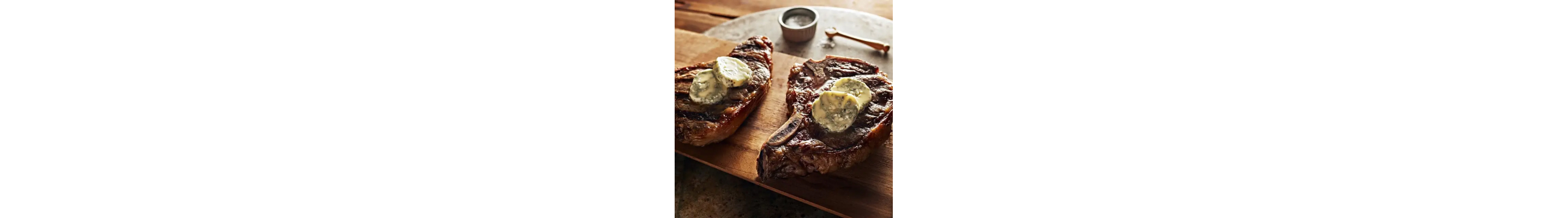 Two t-bone steaks with blue cheese butter